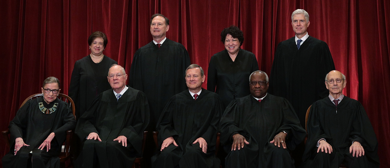 The Supreme Court Justices in 2017, before Justice Anthony Kennedy retired. Thomas is seated in the front row, second from the right.